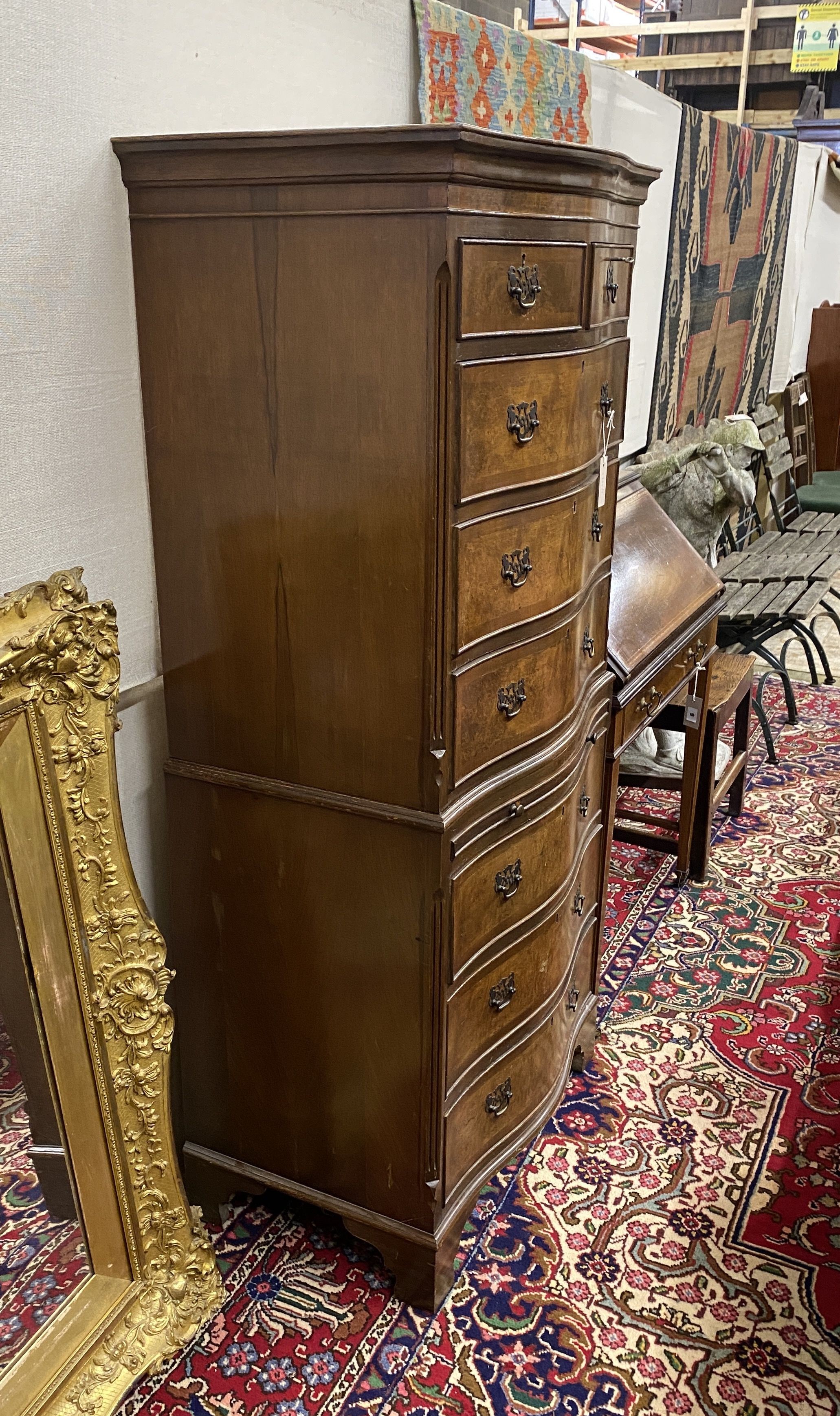 A reproduction George I style walnut serpentine chest on chest, width 70cm, depth 47cm, height 152cm